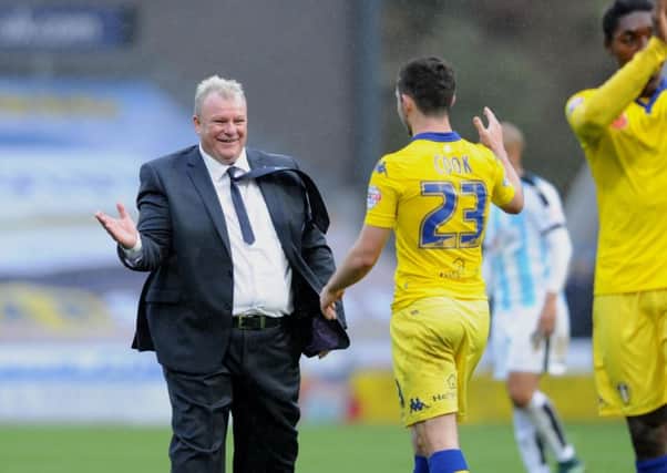 Steve Evans congratulates Lewis Cook after the win.