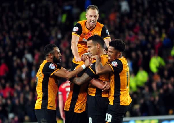 VICTORY SEALED: Hull City players mob Tom Huddlestone after he scored their third goal in the Championship game against Middlesbrough. Picture: Jonathan Gawthorpe