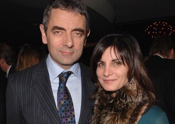 Rowan Atkinson and his wife Sunetra Sastry who has been granted a divorce on the grounds of his "unreasonable behaviour".