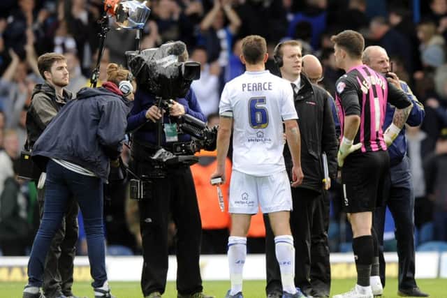 Leeds's Jason Pearce and Owls' Kieren Westwood face the cameras.