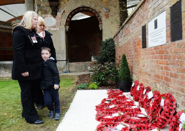 Rebecca Rigby (left), the widow of murdered Fusilier Lee Rigby, and son Jack as they attend a service at St George's Chapel in Woolwich, to mark Armistice Day.
