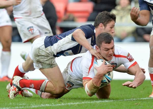 England's Brett Ferres goes over for a try during the International Test match at Leigh Sports Village.