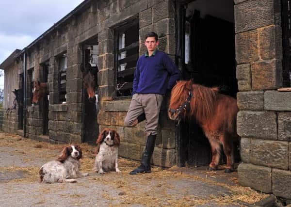 Jonathan England, with racehorse companion Benji in the yard at Guiseley, Leeds.