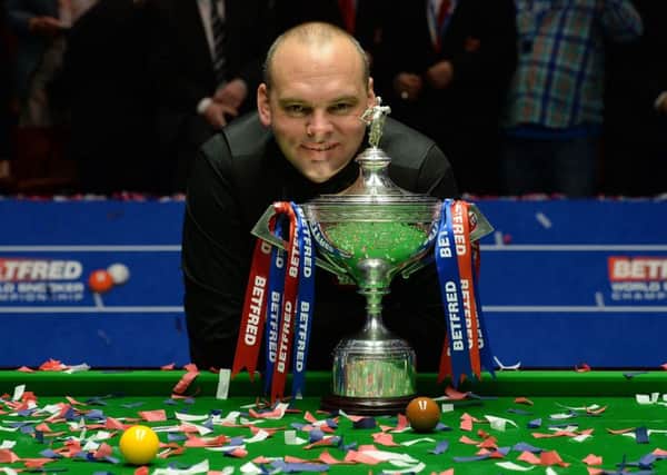 Stuart Bingham celebrates with the trophy after winning the final of the Betfred World Championships.
