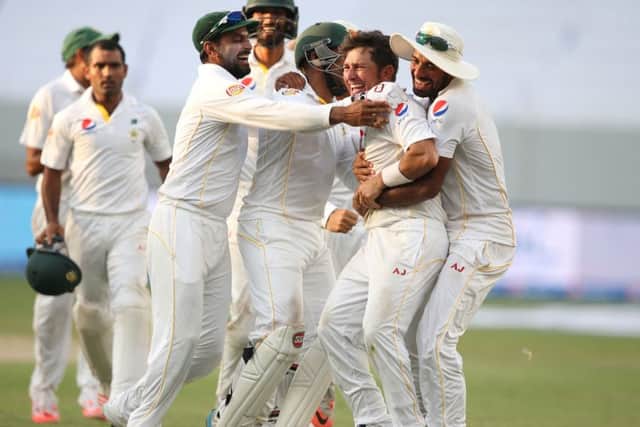 Pakistan's players celebrate with their team-mate Yasir Shah, second right, after the dismissal of England's Adil Rashid during the Pakistan and England Test match at the Dubai International Stadium in Dubai. (AP Photo/Kamran Jebreili)