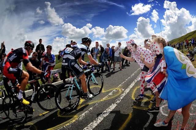 Fans Cheer on cyclists as they tackle the Holme Moss climb on the Tour de France Stage 2..6th July 2014 ..Picture by Simon Hulme