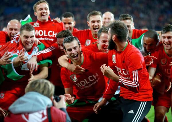 Wales' Gareth Bale (centre) celebrates with his team-mates after qualifying for Euro 2016.