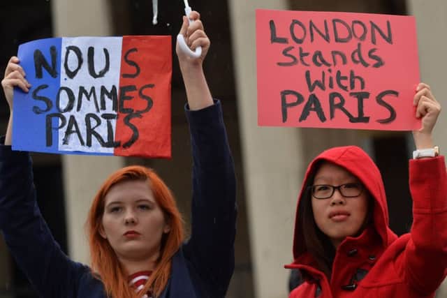 Two women attend a vigil in Trafalgar Square in London