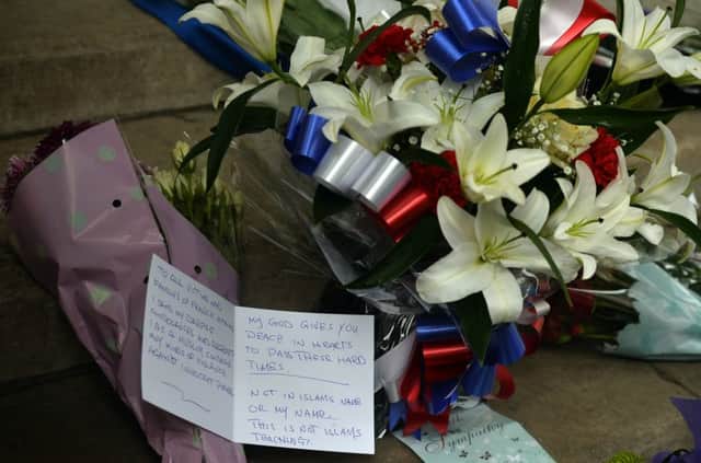 Flowers and tributes are left outside the French Embassy in London after the terror attacks. PIC: PA