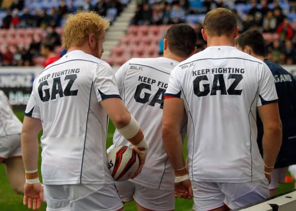Players wearing "keep fighting Gaz" T-shirts showing support for Gary Carter, the Rugby League journalist who is fighting for his life in hospital.