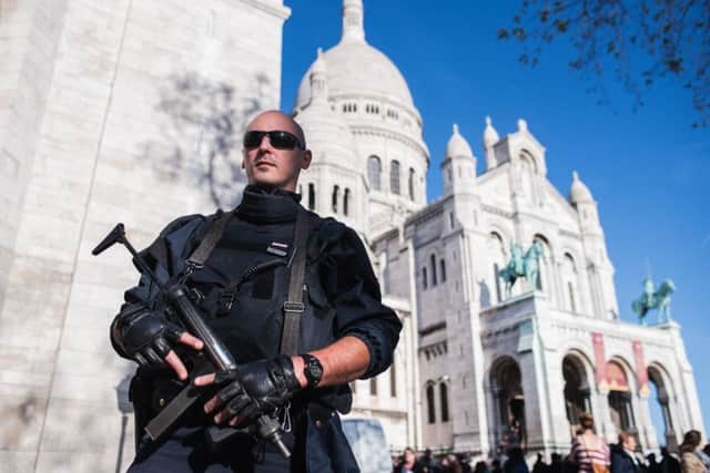 A French police officer patrols at the Sacre Coeur basilica in Paris