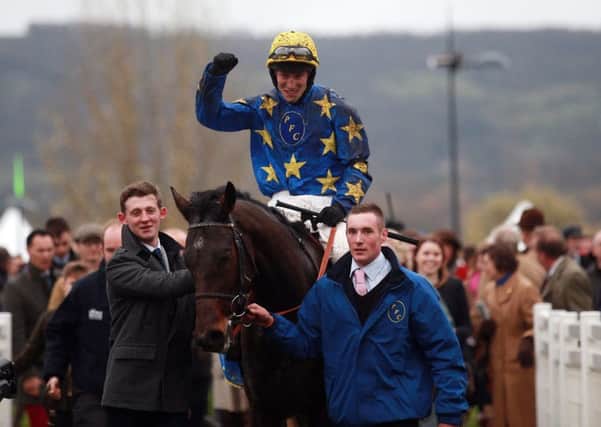 Jockey Ian Popham celebrates his victory onboard Annacotty in the Paddy Power Gold Cup Chase.