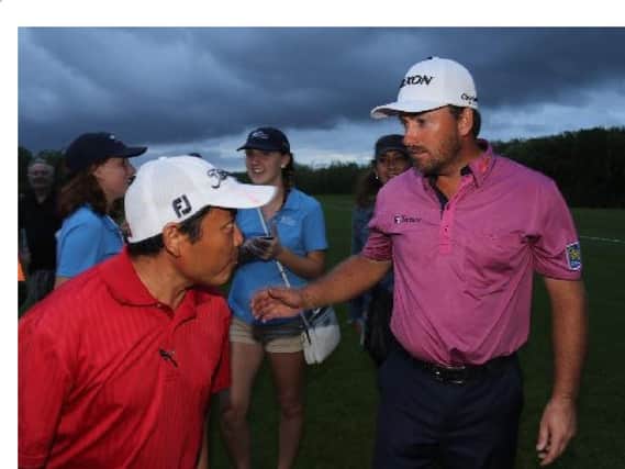Eventual winner Graeme McDowell talks with fans before play was suspended in the OHL Classic in Mexico (Picture: Israel Leal/AP.