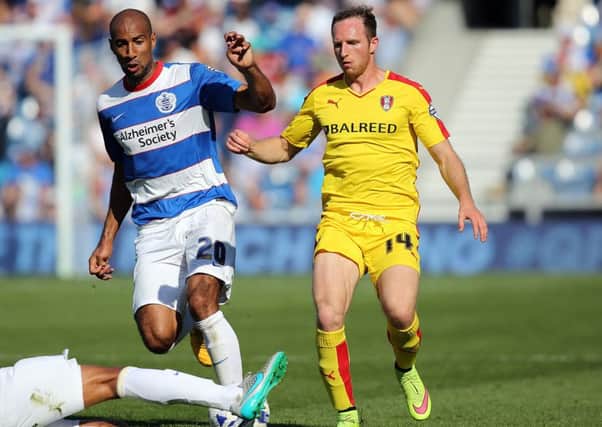 Rotherham's Aidy White, pictured holding off the attention from QPR's Karl Henry, has joined Barnsley on loan