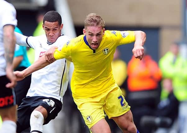 Charlie Taylor is challenged by Tom Ince.