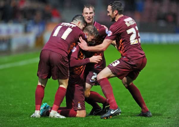 Bradford City's Gary Liddle is mobbed after scoring the first goal. Picture Tony Johnson