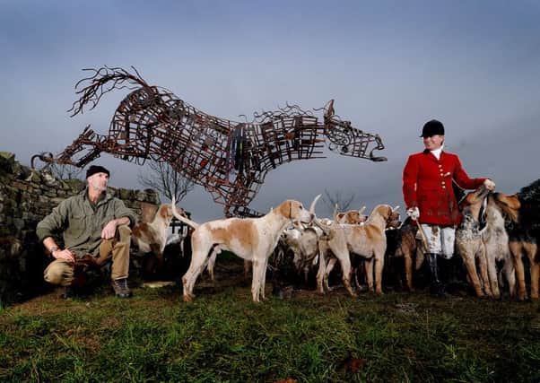Metal work artist Stego Parker near his sculpture at Low Swainby Farm, Pickhill. Admiring the artwork is Daphne Bourne-Arton, Master & Huntsman (MFH) of the West of Yore Hunt and her hounds.