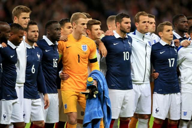 England players stand side by side with their French counterparts before the international friendly match at Wembley Stadium, London. PRESS ASSOCIATION Photo.