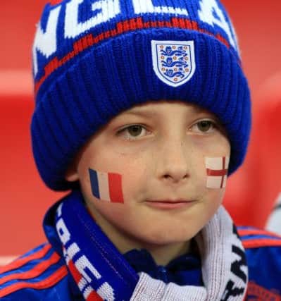 Young fans in the stands with facepaint of France and England flags prior to the international friendly match at Wembley Stadium, London. PRESS ASSOCIATION Photo.