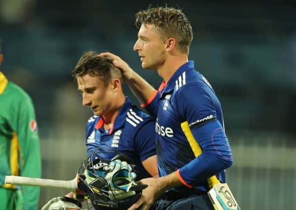 England batsmen James Taylor, left, and Jos Buttler leave the pitch after steering their side to a six-wicket victory in the third ODI against Pakistan. England lead the series 2-1 (Picture: Kamran Jebreili/AP).