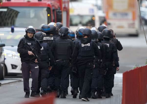 A police special intervention unit moves towards the scene of the siege in Paris.