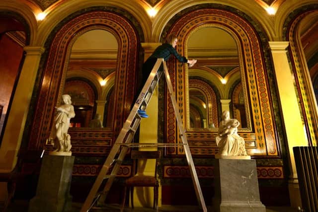 Caroline Rawson, collection conservator, cleaning the mirrors in the West Hall. PIC: Scott Merrylees