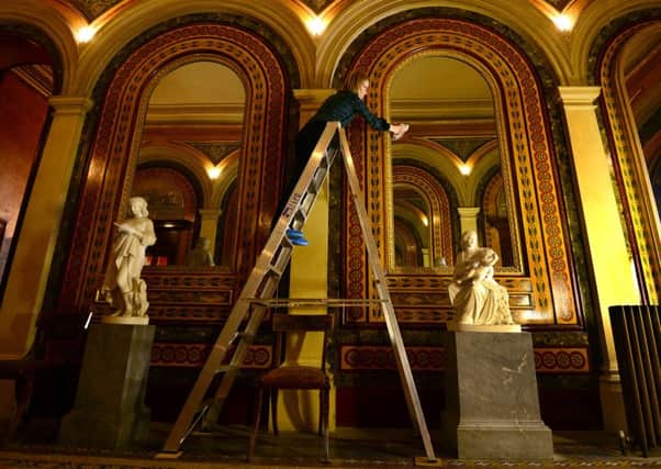 Caroline Rawson, collection conservator, cleaning the mirrors in the West Hall. PIC: Scott Merrylees