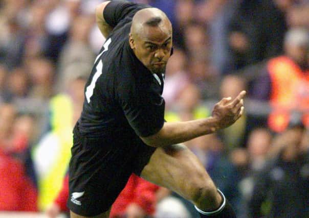 Jonah Lomu gives Austin Healey the slip and runs on to score his team's second try during the Rugby World Cup match against England at Twickenham in 1999. (Tom Hevezi/PA Wire.)