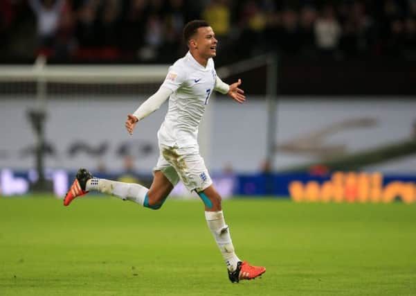 England's Dele Alli celebrates scoring his side's first goal during the international friendly with France.