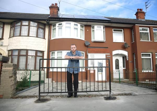 Adam Storey at his home in Hull where the council have erected an ugly metal fence blocking his drive and preventing him charging his eco electric car. Picture: Ross Parry Agency