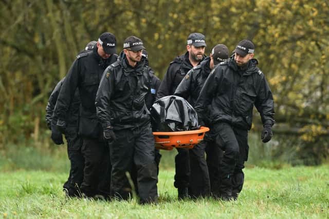 Police remove a body on a stretcher from undergrowth around a lake in Ibstock, Leicestershire, where they have been searching for missing Kayleigh Haywood.