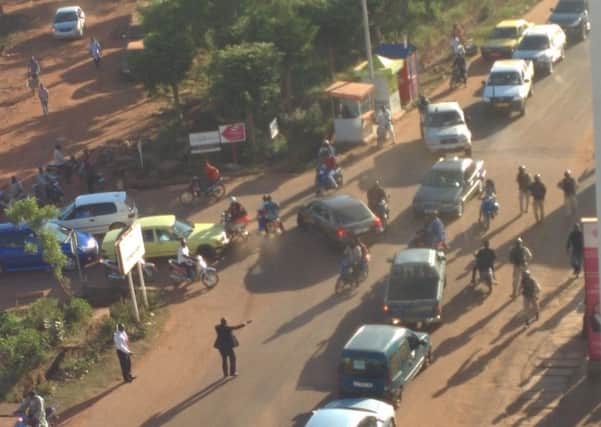 Security force personnel escort people fleeing from the Radisson Blu Hotel in Bamako, Mali