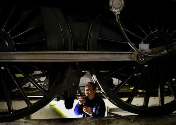 Darrin Crone, a locomotive engineer from the  Sir Nigel Gresley Locomotive Trust, underneath the steam engine Sir Nigel Gresley as it begins its 10 yearly overhaul
