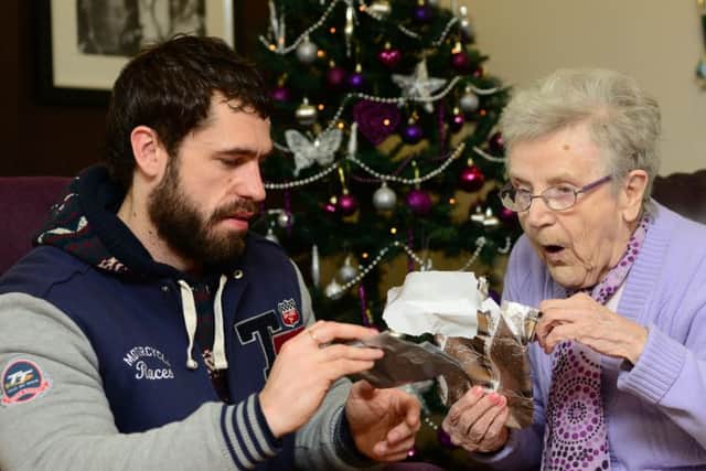 Emmerdale actor Kelvin Fletcher, aka Andy Sugden, delivering presents to Mary Cafferty at Ashworth Grange Care Home in Dewsbury, as part of Gift for Granny in 2014.
Picture Scott Merrylees