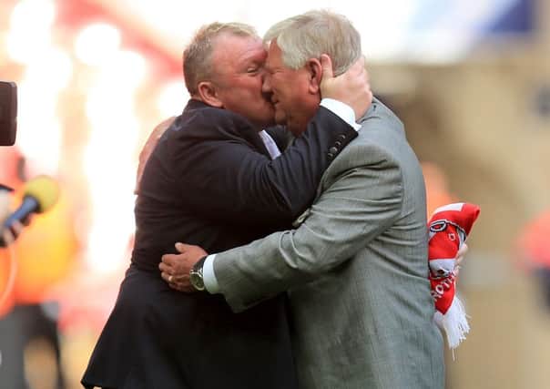 Rotherham United chairman Tony Stewart emraces former manager Steve Evans after winning promotion from League One through the play-offs.