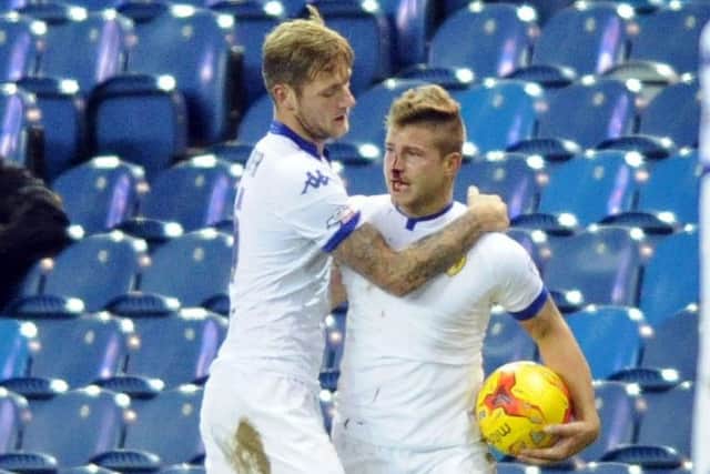 Gaetano Berardi  is held back by Leeds United team-mate Liam Cooper after an incident with Rotherham Uniteds Leon Best that saw Berardi left bloodied and both sent off (Picture: Simon Hulme).