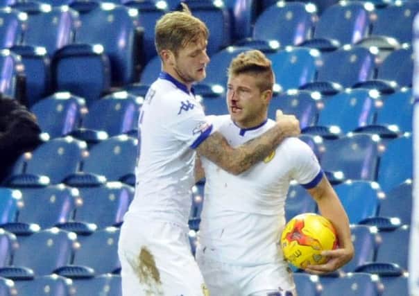 Gaetano Berardi  is held back by Leeds United team-mate Liam Cooper after an incident with Rotherham Uniteds Leon Best that saw Berardi left bloodied and both sent off (Picture: Simon Hulme).