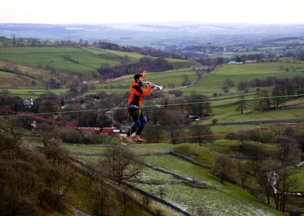 Daniel Laruelle, 21, from Newcastle, took his trumpet and played it on a highline 400ft above the ground ground in Malham in the Yorkshire Dales. Picture: Ross Parry Agency