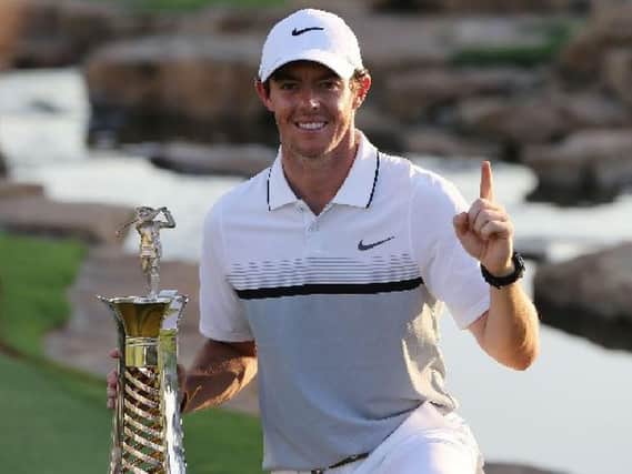 Rory McIlroy poses with the Race to Dubai trophy after he won the DP World Tour Championship in Duba (Picture: Kamran Jebreili/AP).
