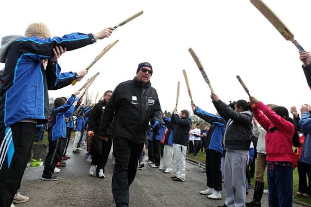 Sir Ian Botham passes through a guard of honour of cricket bats as he walks in Drumpellier Country Park, Coatbridge , during the the first leg of his 14th charity walk, in support of Leukaemia & Lymphoma Research in April 2012.