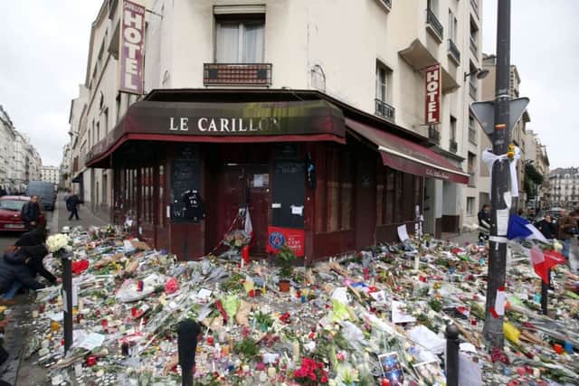 Floral tributes and candles left at Le Carillon, Paris, after terror attacks killed at least 129 people in the city. Photo: Steve Parsons/PA Wire