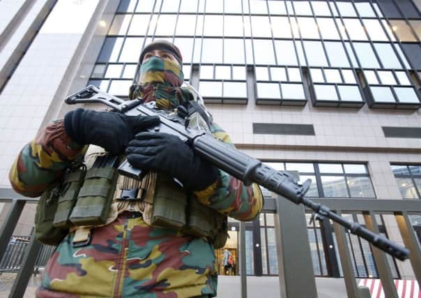A Belgian police officer guards the building of the European Commission in Brussels
