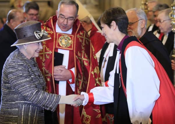 Queen Elizabeth II meets the Bishop of Stockport, the Right Reverend Libby Lane and the Dean of Westminster, Reverend John Hall (centre) as she arrives at Westminister Abbey.