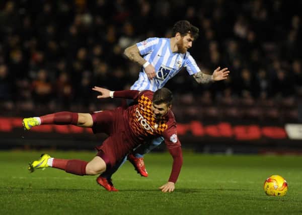 Lee Evans falls as Romain Vincleot takes posession at Valley Parade on Tuesday night.  Picture: Bruce Rollinson
