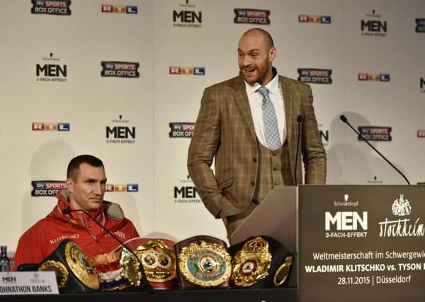 Challenger Tyson Fury talks to the media prior to his heavyweight boxing fight against Ukrainian world champion Wladimir Klitschko, left, in Duesseldorf, Germany (Picture: Martin Meissner/AP).
