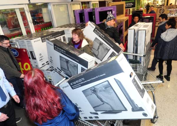 Shoppers grab bargain TVs at an Asda store in Leeds on Black Friday last year, but this time the retailer chose not to take part.  Picture by Tony Johnson.