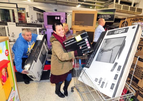 Shoppers grab bargain christmas presents on offer at ASDA Pudsey on Black Friday last year.