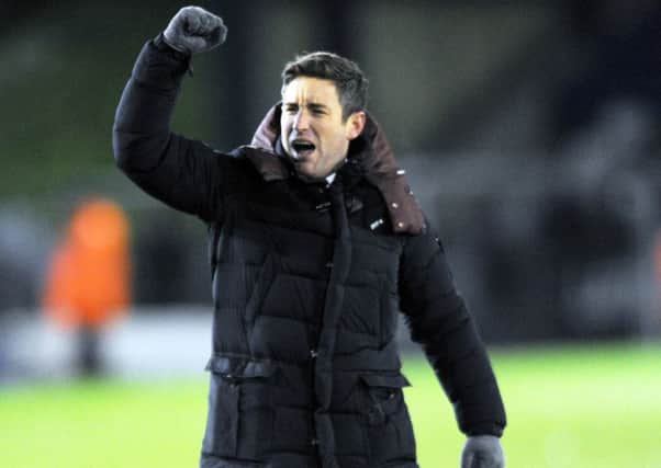 Bansley manager Lee Johnson celebrates victory for the Reds at Oldham