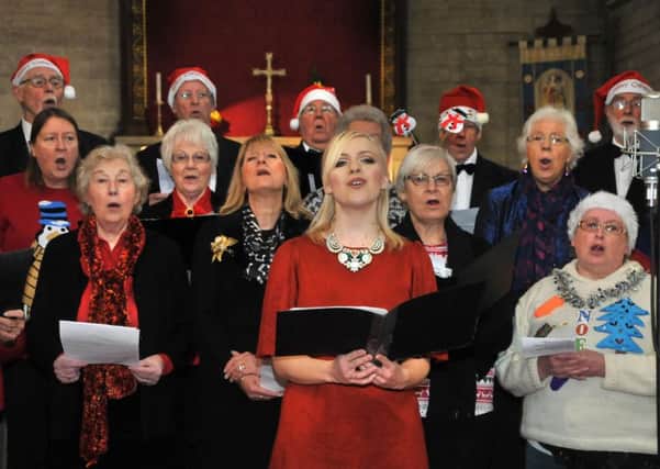 Gospel singer Philippa Hanna with members of Malton Male Voice Choir and the town's Harmonia Choir at St Peters Church for the recording and filming of a song inspired by Charles Dickens' A Christmas Carol. Picture: David Harrison.