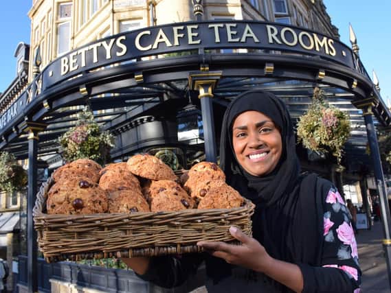 Nadiya Hussain, winner of BBC TV's The Great British Bake Off 2015 with a basket of Fat Rascal;s outside Bettys in Harrogate.